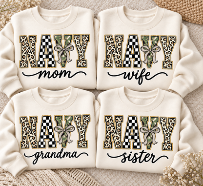 Custom Navy Family apparel shown as four cream sweatshirt flatlays with personalized wording and leopard checkerboard camouflage varsity letters